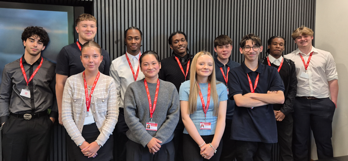 Group of apprentices smiling at the camera in an office setting
